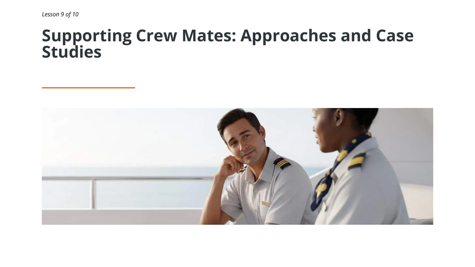 Two superyacht crew members in uniform having a supportive conversation on deck, demonstrating peer support and mental health awareness training for maritime professionals