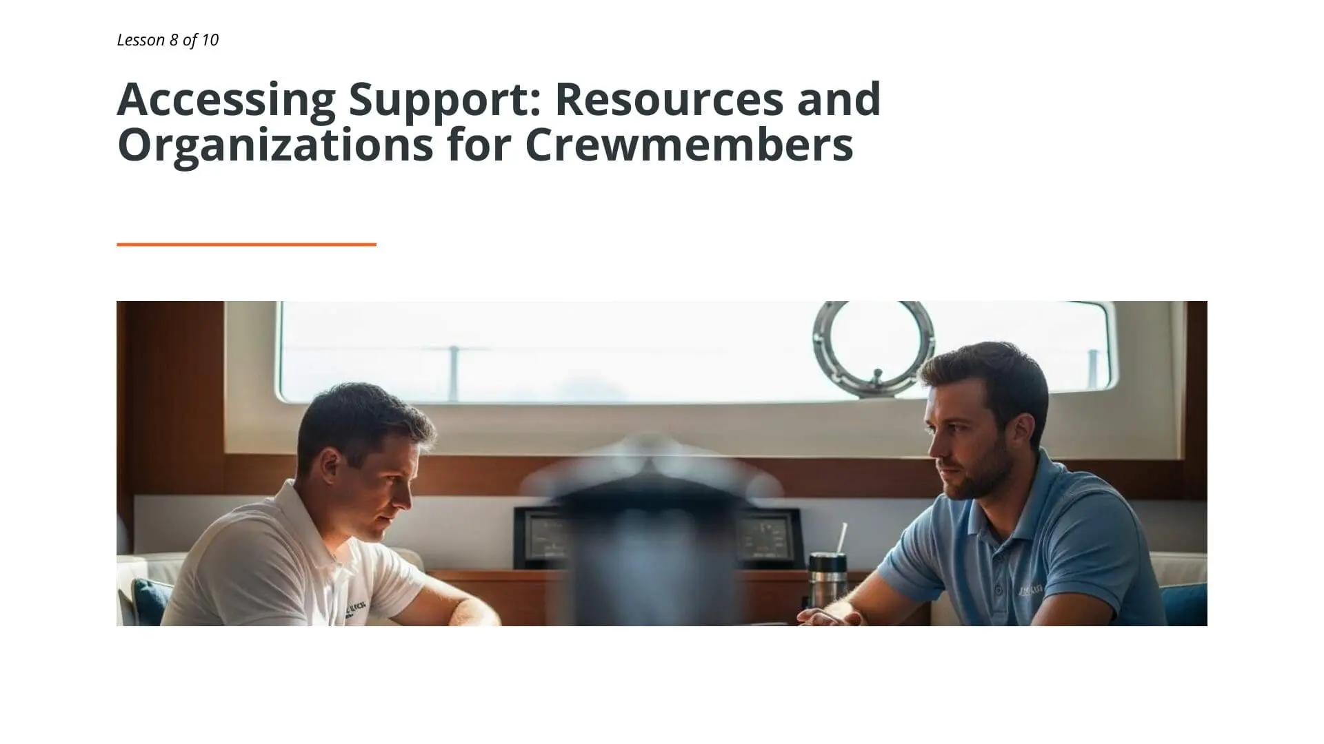 Two superyacht crew members in discussion inside a yacht cabin, representing mental health support and peer guidance for maritime professionals