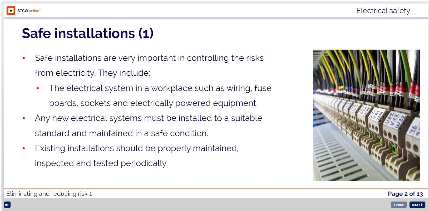 Electrical distribution panel with organized wiring, cables, and terminal blocks labeled for workplace safety compliance