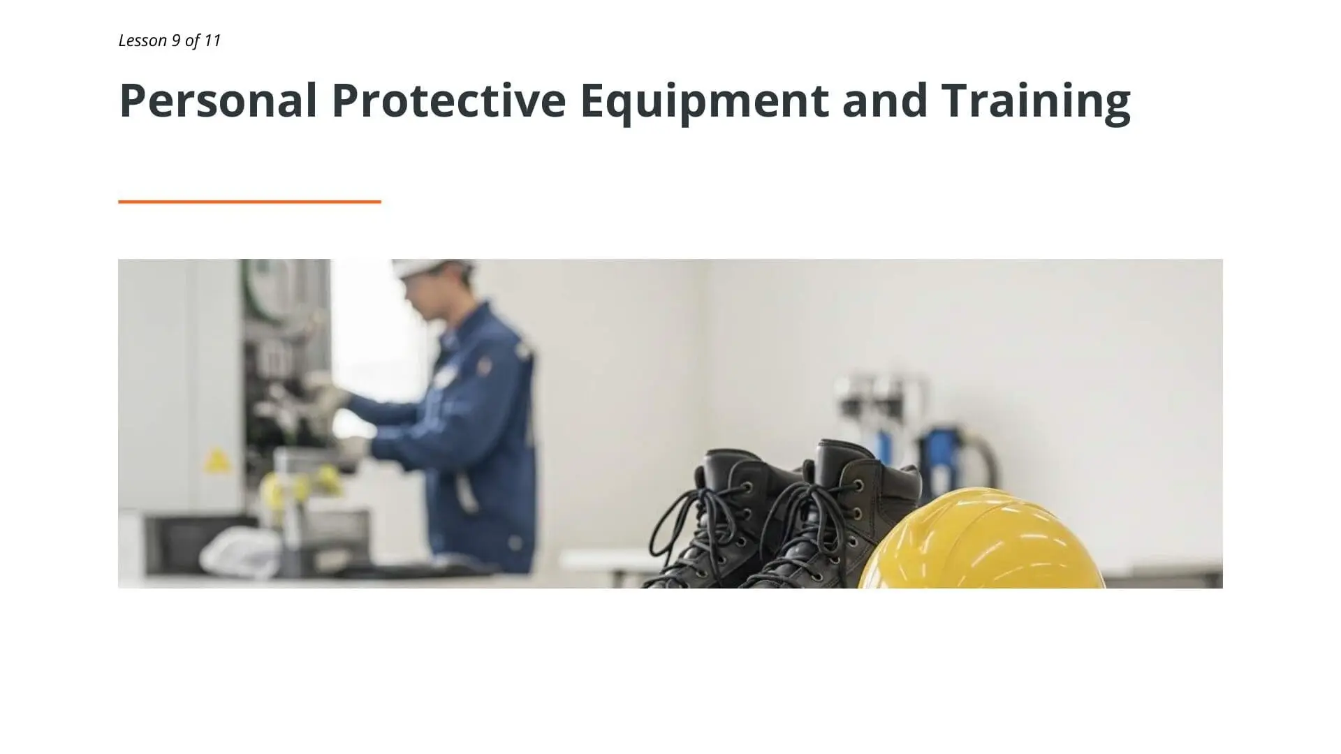 Worker in blue uniform with safety equipment including yellow hard hat and black boots, demonstrating proper personal protective equipment for manual handling training