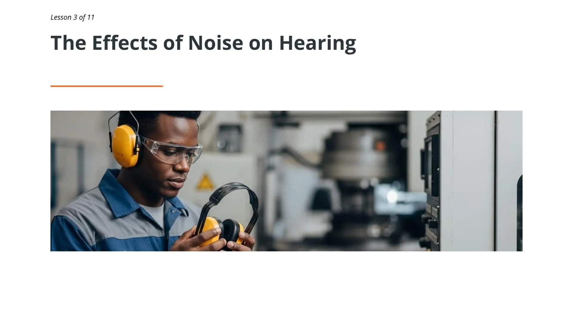 Industrial worker wearing yellow earmuffs and safety glasses in factory setting, demonstrating proper hearing protection for noise awareness training
