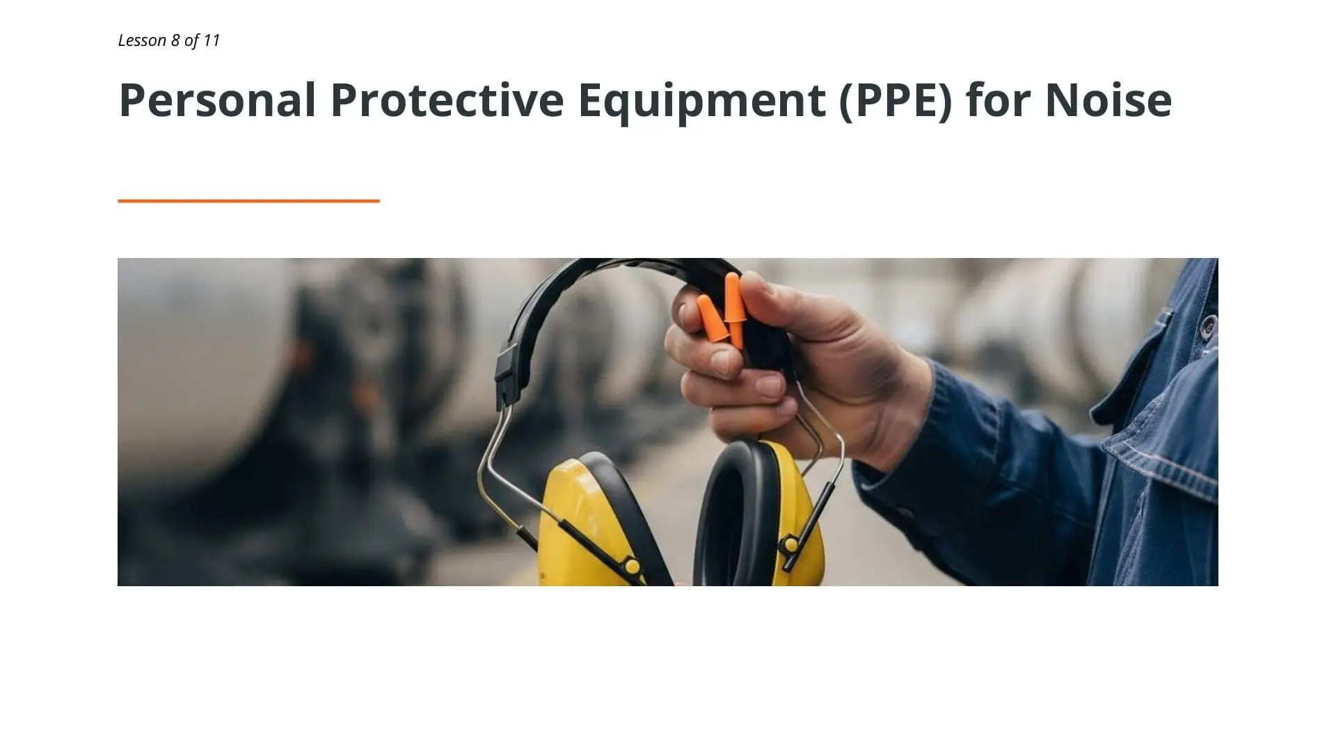 Worker holding yellow and black noise-canceling earmuffs for hearing protection in industrial workplace safety training
