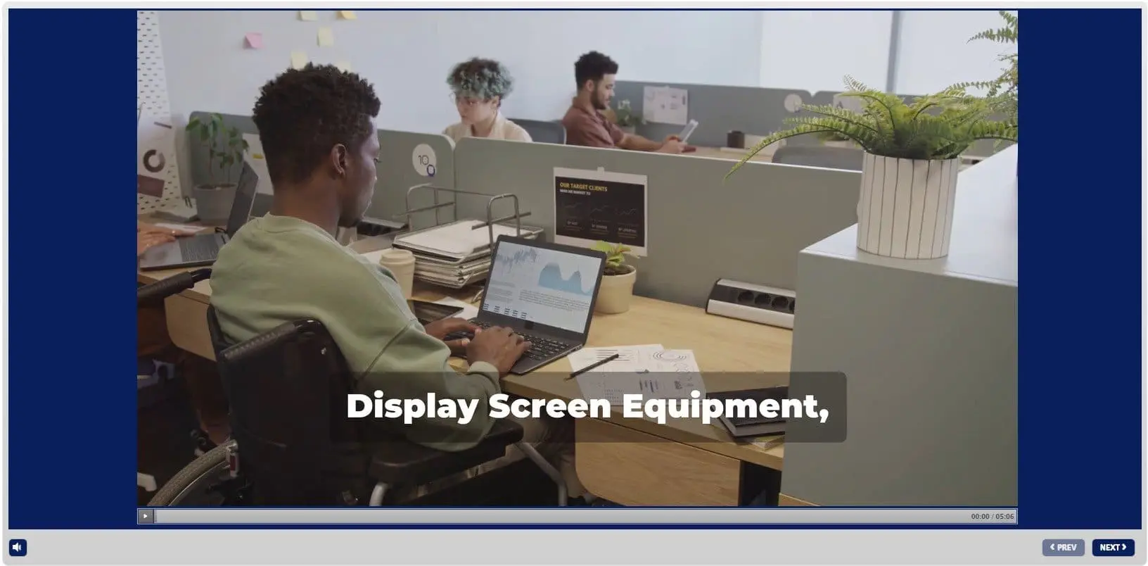 Professional working at laptop in maritime office with display screen equipment and colleagues at workstations