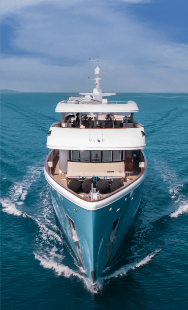 Luxury motor yacht sailing on turquoise ocean waters, representing maritime training and professional seafaring education