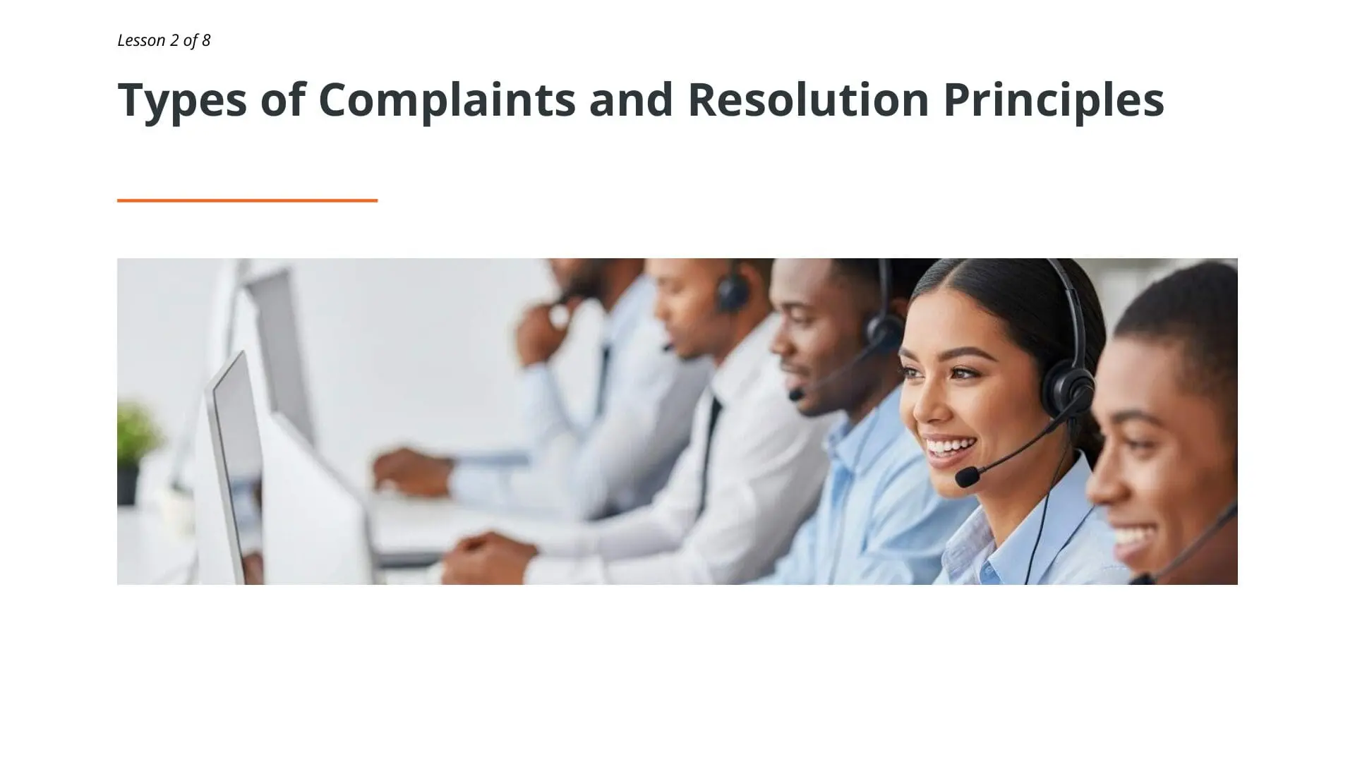 Professional customer service representatives wearing headsets in a training session for complaint handling and resolution principles