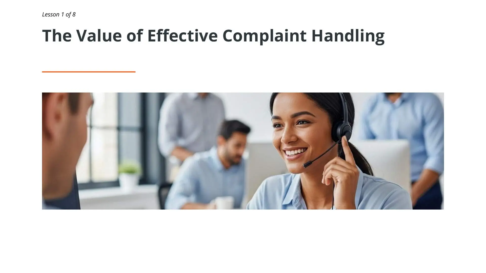 Smiling customer service representative wearing headset handling complaint in modern office environment with team members in background