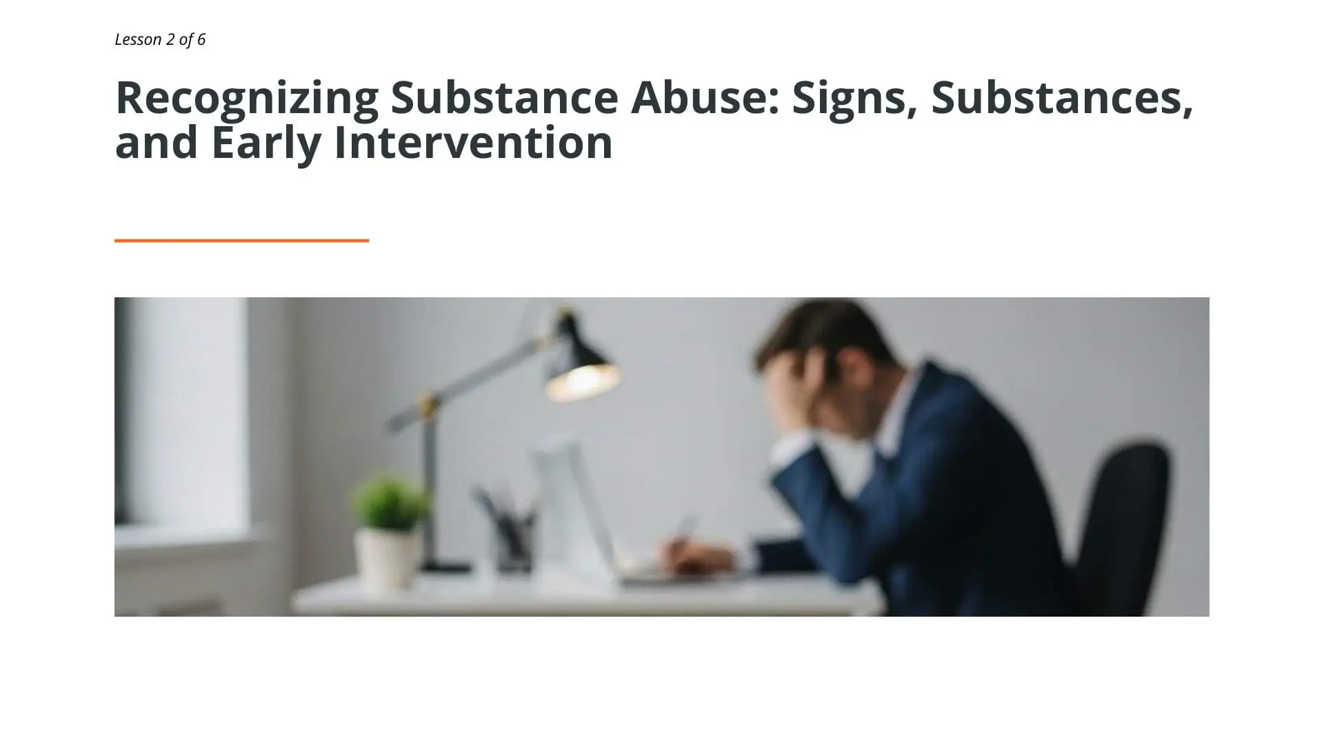 Professional at desk reviewing substance abuse recognition materials for maritime workplace drug and alcohol awareness training