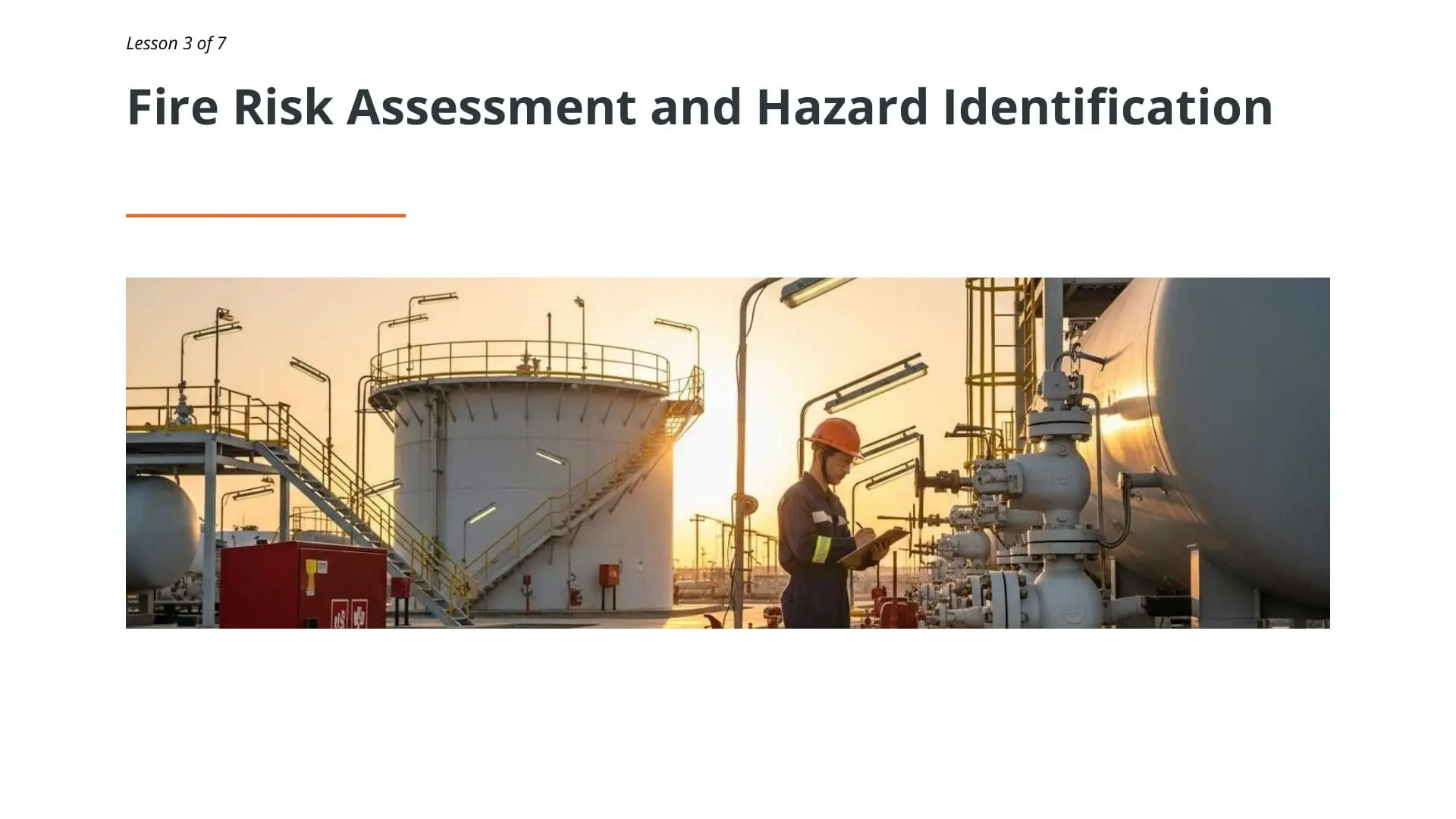 Industrial oil and gas facility with worker conducting fire risk assessment among storage tanks and pipeline equipment at sunset