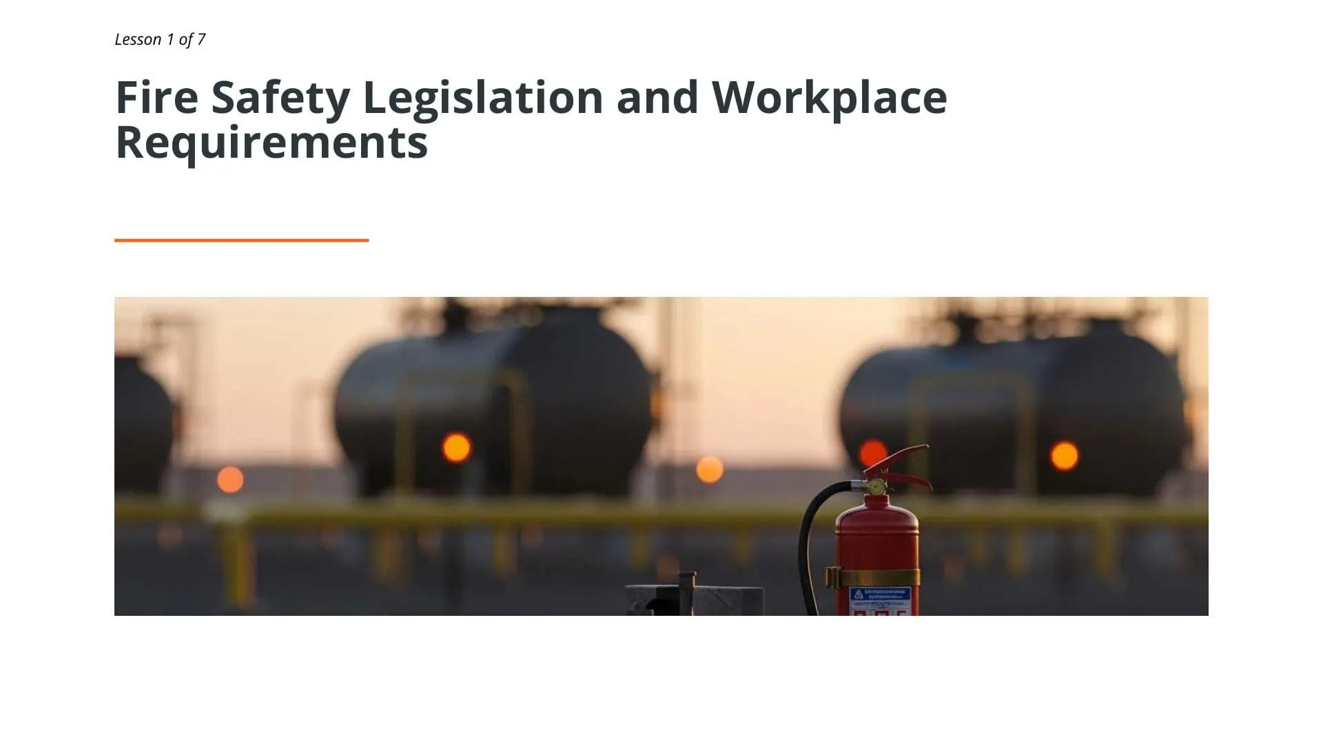 Fire extinguisher in foreground with industrial storage tanks and warning lights in background, representing fire safety equipment for oil and gas workplace environments
