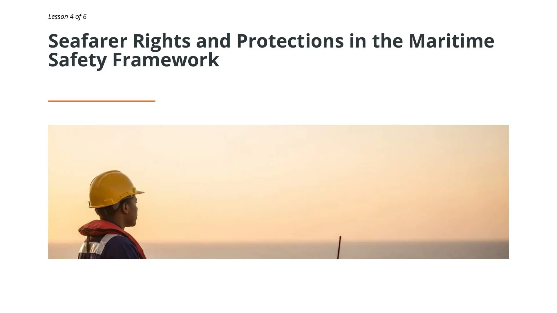 Maritime worker wearing hard hat and safety vest at sea during sunset, representing seafarer protections in maritime safety framework for STCW compliance training