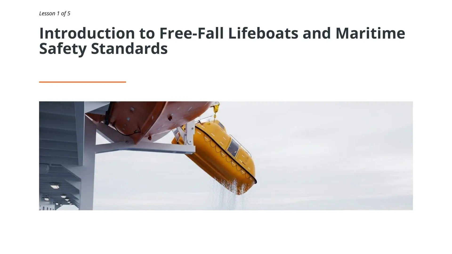 Yellow free-fall lifeboat being deployed from ship davit during maritime safety training lesson