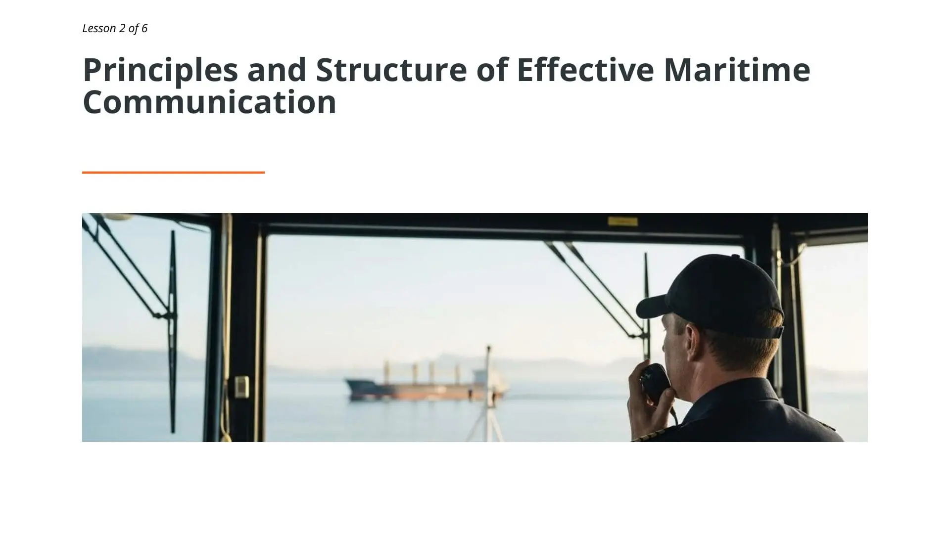 Maritime professional communicating via radio from vessel bridge with cargo ship visible on horizon, demonstrating STCW maritime communication training