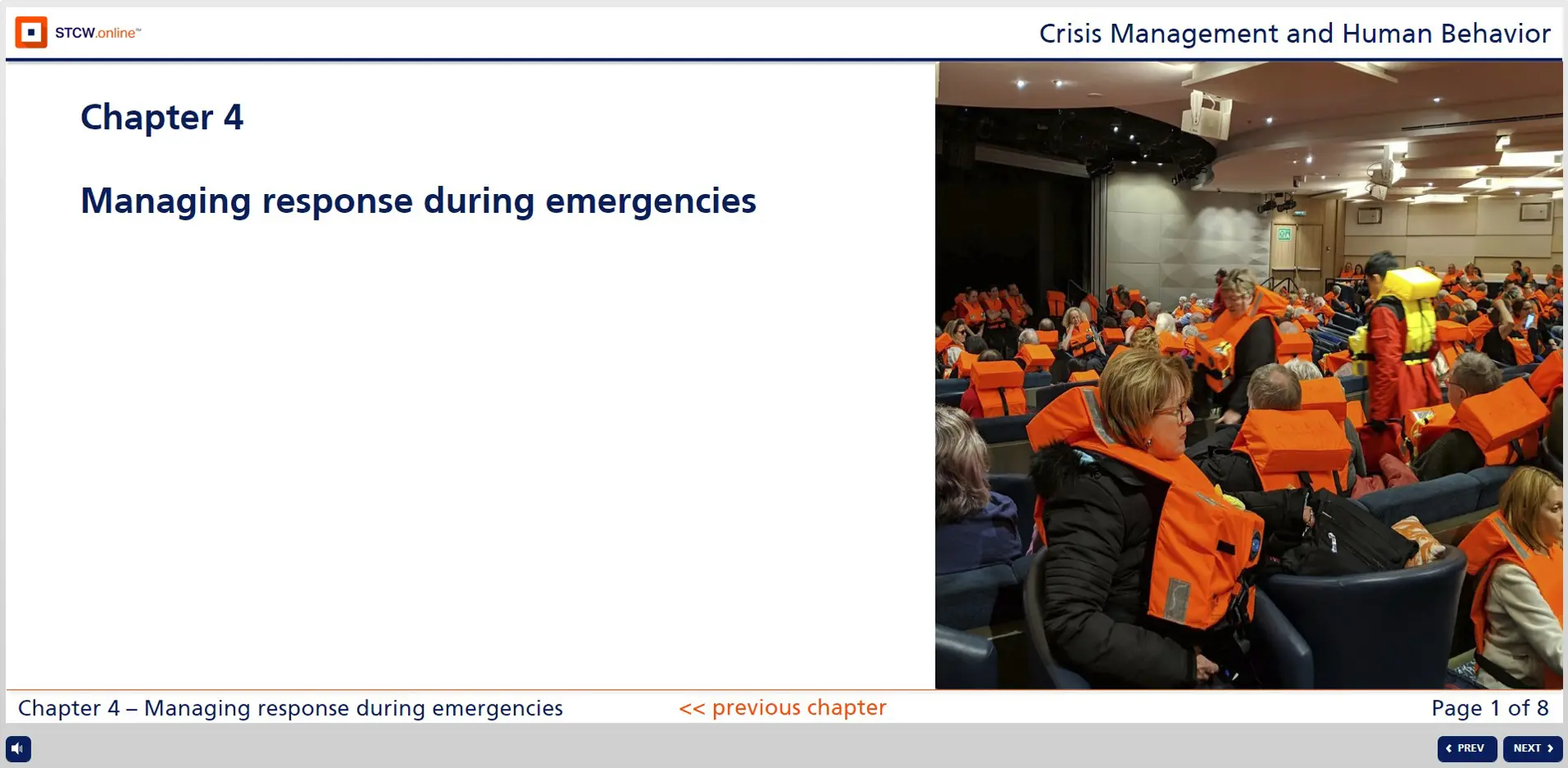 Large group of people wearing orange life vests seated in emergency assembly area during crisis management evacuation drill training