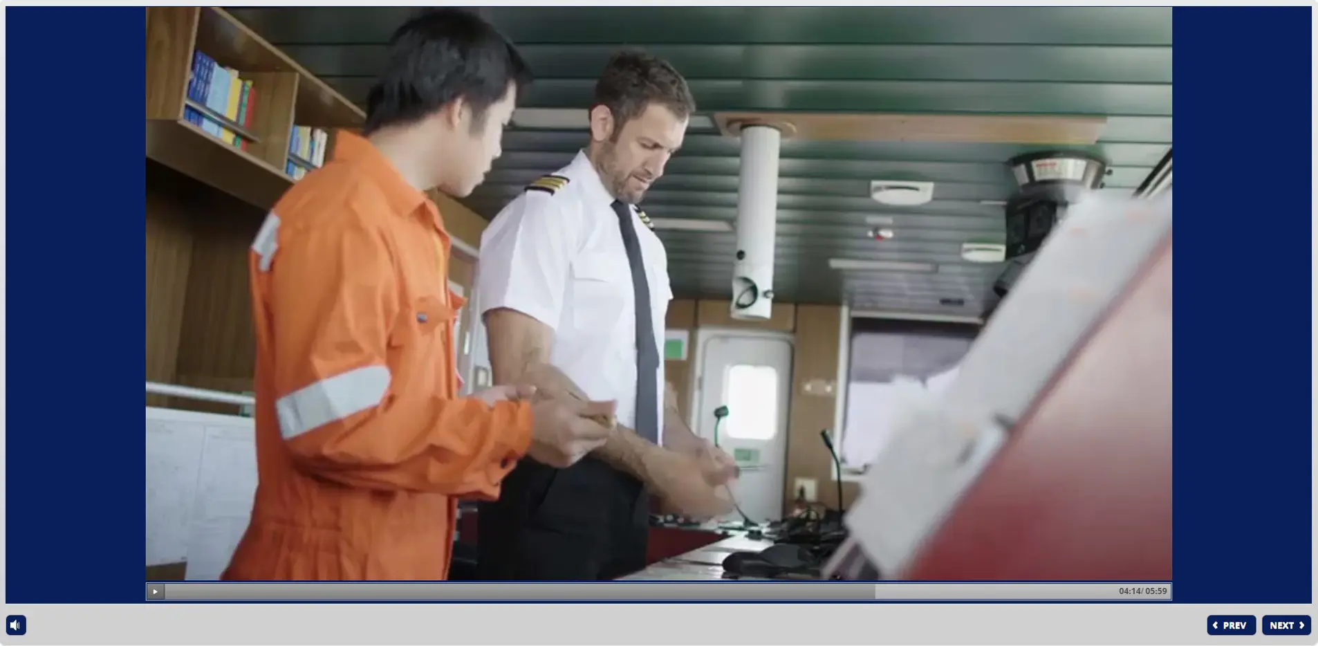 Ship security officer instructing crew member on designated security duties procedures in vessel cabin during online STCW training
